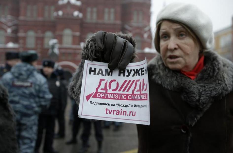 A participant holds a flyer during a protest against the threat of closure to television station Dozhd (TV Rain) in Moscow February 8, 2014. The flyer reads "We need Dozhd".