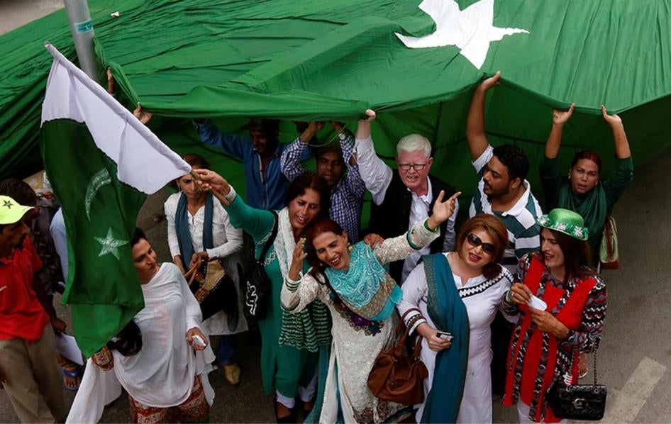 Supporters of the Gender Interactive Alliance dance and chant slogans as they pose with a national flag ahead of the Independence Day in Karachi, August 13, 2016.