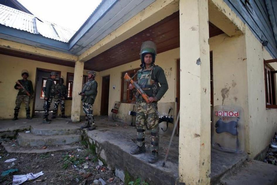 Indian police stand guard outside a polling station in Srinagar, Jammu and Kashmir, on April 13, 2017. 