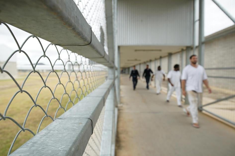 Staff escort prisoners, including Aboriginal and Torres Strait Islander prisoners, through Lotus Glen Correctional Centre. 