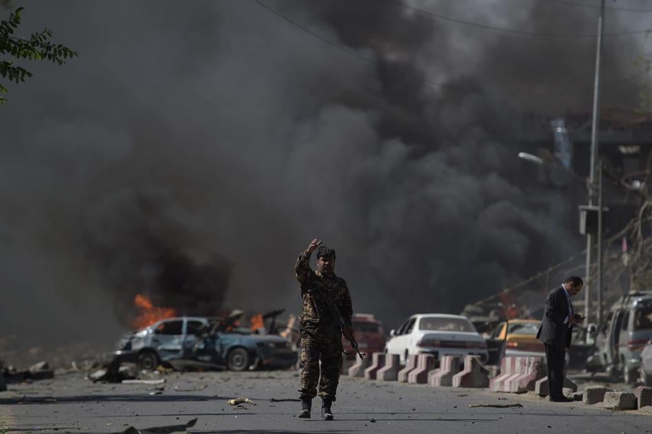 An Afghan security force member stands at the site of a car bomb attack in Kabul on May 31, 2017. At least 40 people were killed or wounded on May 31 as a massive blast ripped through Kabul's diplomatic quarter, shattering the morning rush hour and bringi