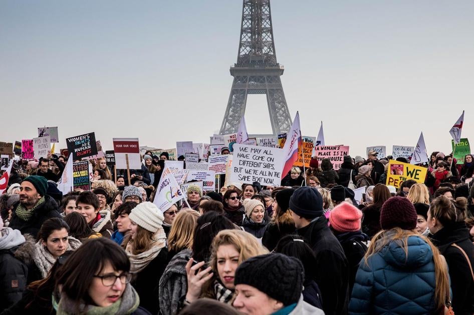 Demonstrators carrying banners and placards take part in the Women's March next to the Eiffel Tower on the Parvis des Droits de l'Homme on January 21, 2017 in Paris, France. 