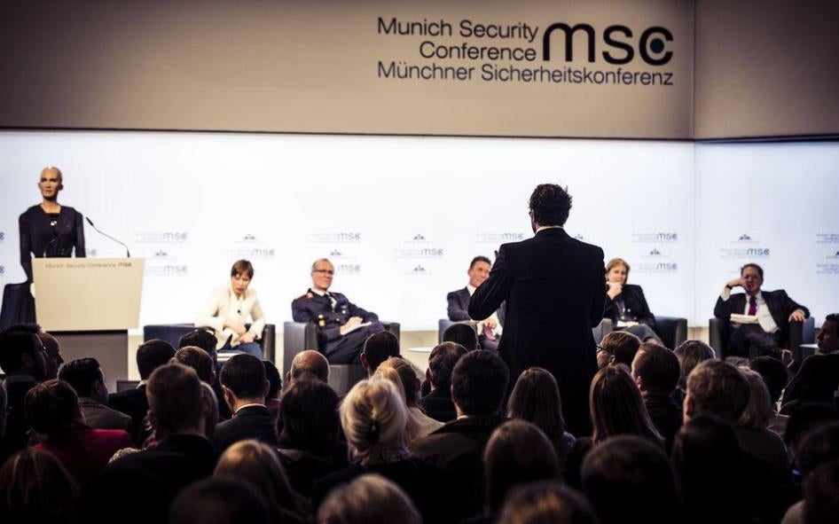Audience members pose questions on AI and modern conflict at a town hall meeting of the Munich Security Conference in February 2018.