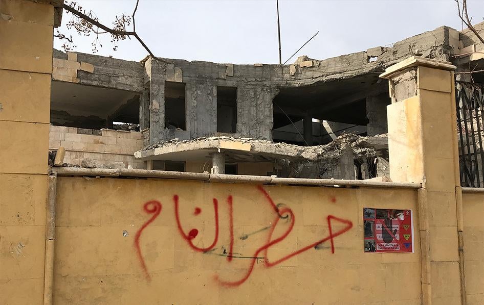 Warning about mines written on outside wall of building in Raqqa, Syria, January 21, 2018.