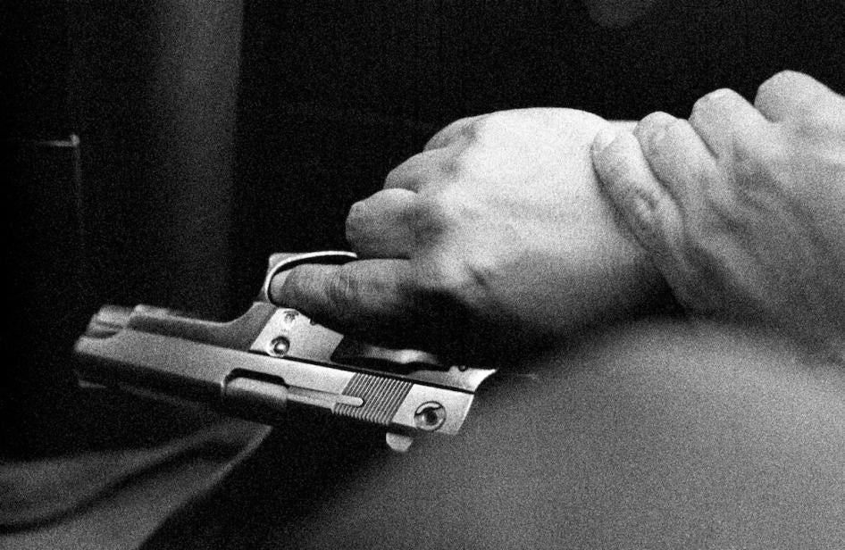 Hands of the bodyguard of Medellín’s human rights ombudsman, Jorge Ceballos. Ceballos was the target of numerous death threats by right-wing armed groups due to his work as a human rights defender.