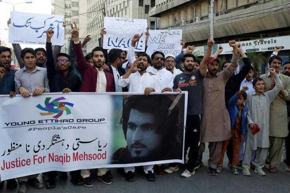 People chant slogans and hold signs as they condemn the death of Naqibullah Mehsud, whose family said he was killed by police in a so-called "encounter killing", during a protest in Karachi, Pakistan January 21, 2018.