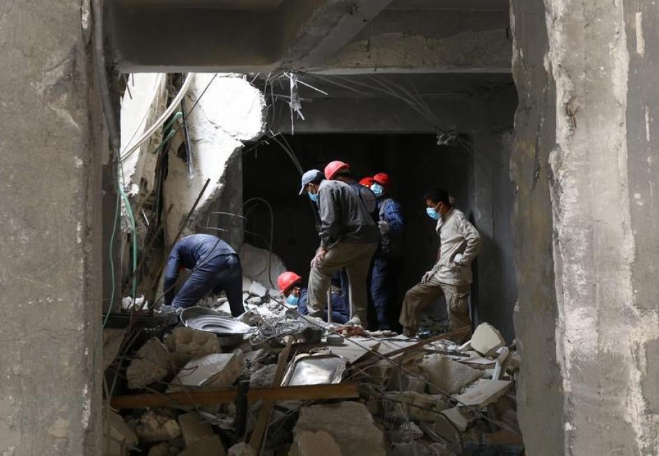 Rescue workers search for bodies still trapped under mounds of debris in Raqqa, Syria April 9, 2018. 