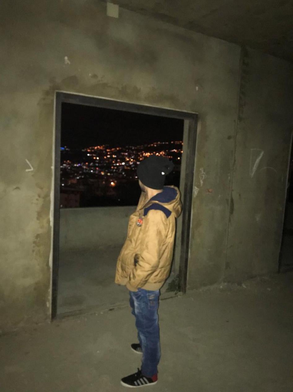 “Omar,” a Syrian refugee evicted from Hadath, looks out the window of the abandoned building he now inhabits in Mazraet Yachouh, Lebanon. “I lived in Hadath for nine years… I was crying to lose my neighbors and my landlady. It was like losing my family,” 
