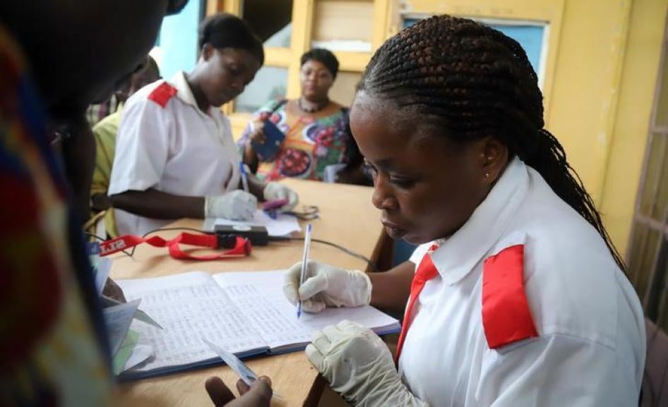 A Congolese health worker records medical data of passengers at the airport in Mbandaka, Democratic Republic of Congo, May 19, 2018.