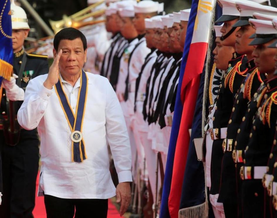 Philippine President Rodrigo Duterte salutes while passing the honour guards upon arrival during the 120th Philippine Navy anniversary in Metro Manila, Philippines May 22, 2018.