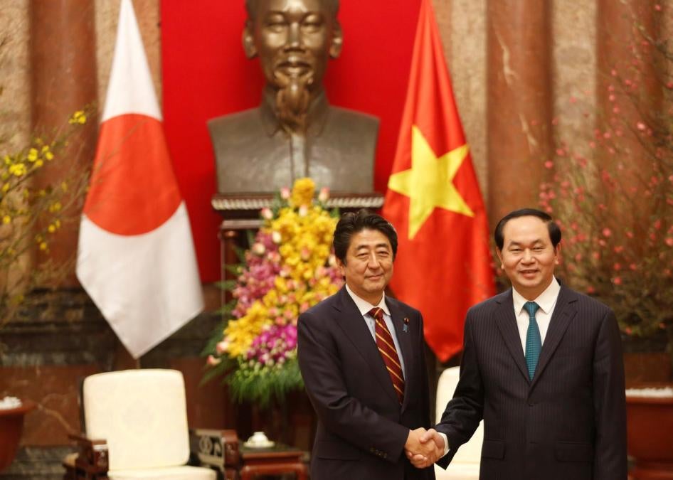 Japan’s Prime Minister Shinzo Abe shakes hands with Vietnam’s President Tran Dai Quang at the Presidential Palace in Hanoi, Vietnam, January 16, 2017.
