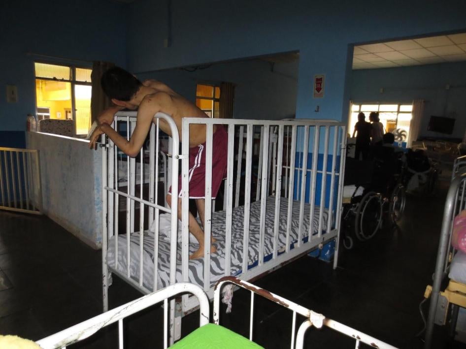 In many institutions, staff use beds with high bars to confine persons with disabilities.