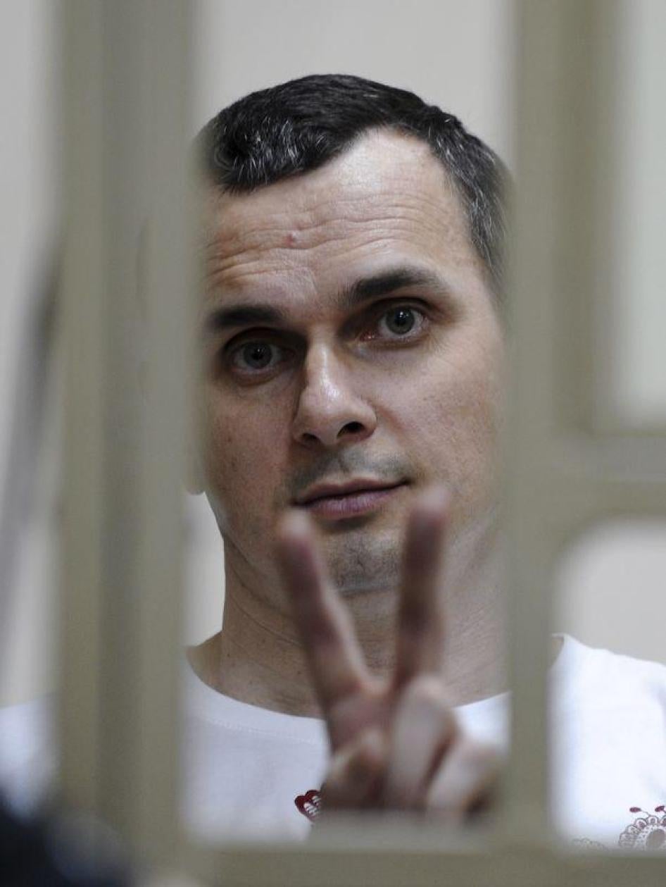 Ukrainian film director Oleg Sentsov gestures from a defendants' box as he attends a court hearing in Rostov-on-Don, Russia, July 21, 2015. 
