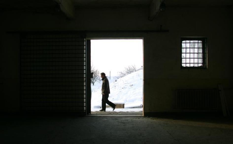 A Romanian journalist walks past a building on the Mihail Kogalniceanu Airbase, 250km (155 miles) east of Bucharest, cited as a possible location for the transfer of terrorist suspects by the CIA. December 19, 2005.