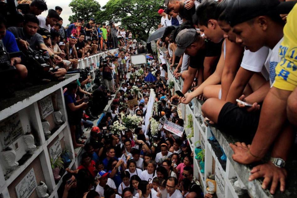 Mourners watch as Kian delos Santos, a 17-year-old student who was shot during anti-drug operations, is buried in Metro Manila, Philippines, August 26, 2017.
