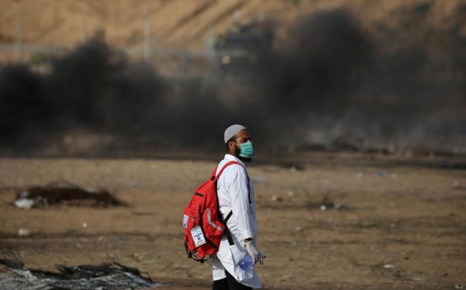 A medic looks on during a demonstration near the separation fence with Israel in southern Gaza, May 18, 2018.
