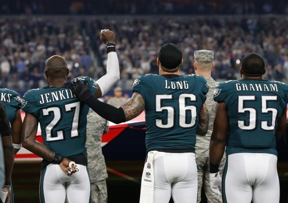 Philadelphia Eagles safety Malcolm Jenkins (27) raises his fist during the national anthem with support from team mate Chris Long (56) prior to the game against the Dallas Cowboys at AT&T Stadium.