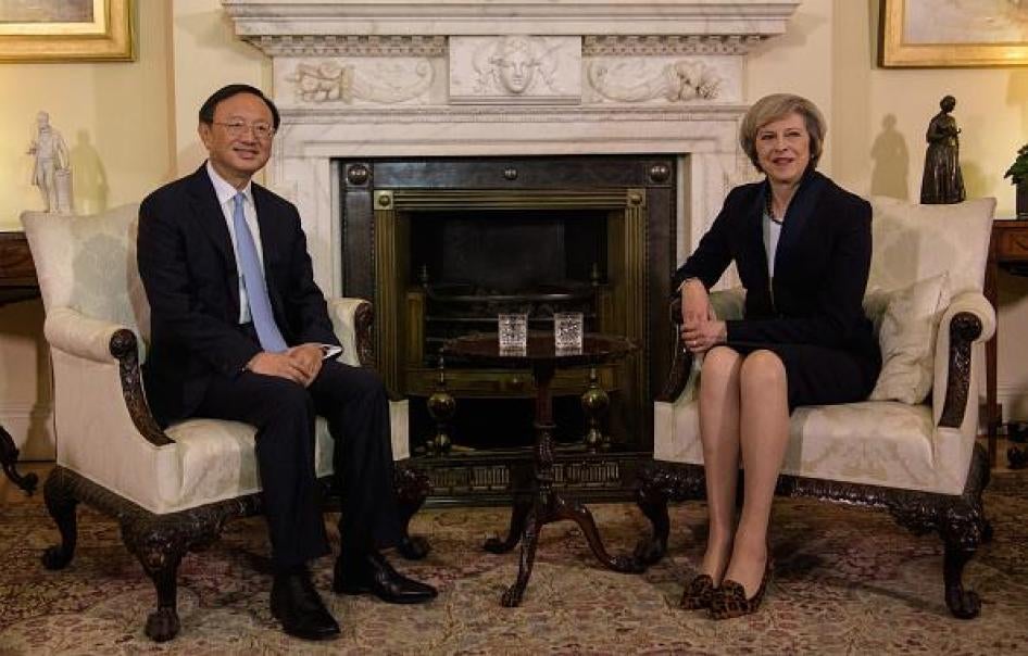 British Prime Minister Theresa May (R) sits with Chinese State Councillor Yang Jiechi (L) for a meeting at 10 Downing Street in London on December 20, 2016.