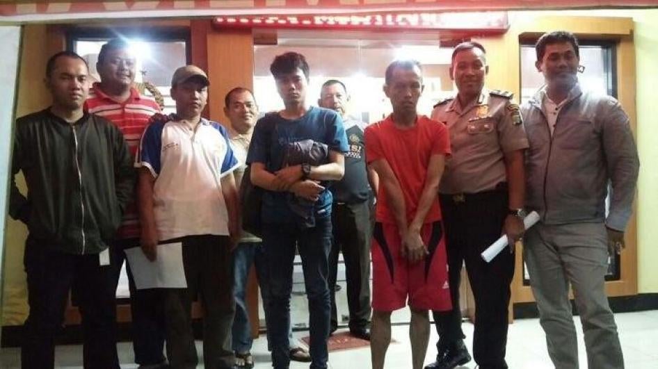 Police parade a same-sex couple they arrested in March 2018 before the media. Neighbors in Jakarta suspected the men were gay, and entered their private home, turning them over to the police. 