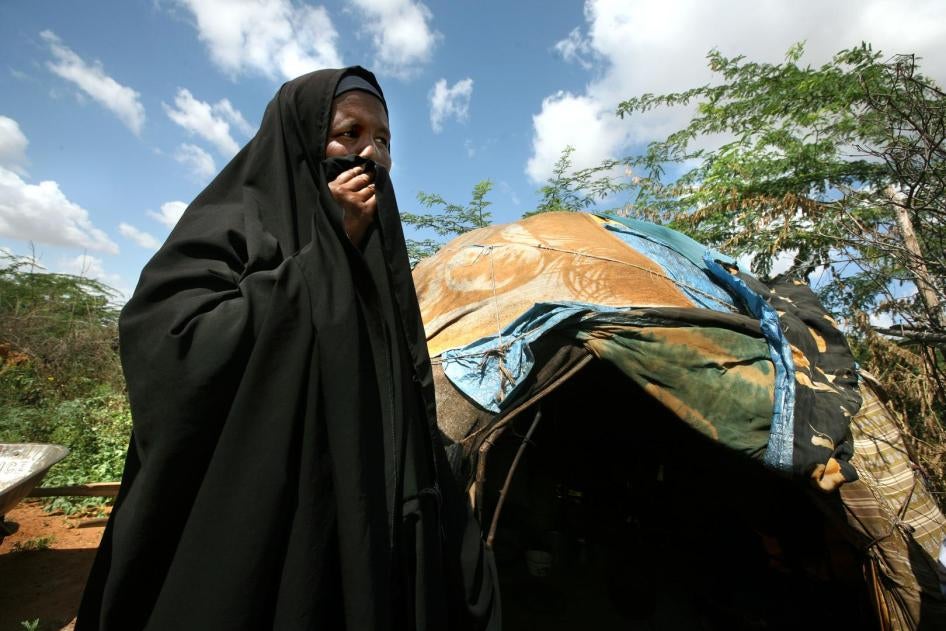 A refugee woman from Imey, a town in the Gode zone of Ethiopia's Somali Region, stands outside her makeshift home in Dadaab refugee camp in northern Kenya. She and her children fled to Kenya after her husband was killed by Ethiopian forces in December 200