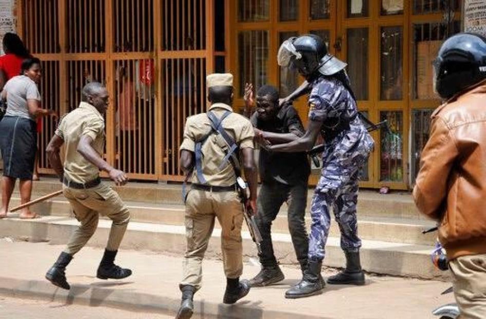 Ugandan security forces briefly beat then detain a protester in downtown Kampala, Uganda, Monday, Aug. 20, 2018. Ugandan police fired bullets and tear gas to disperse a crowd of protesters demanding the release of jailed lawmaker, pop star, and government