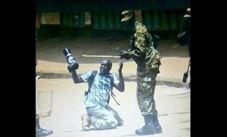Ugandan soldiers surround and beat photographer James Akena in Kampala during protests on August 20, 2018.