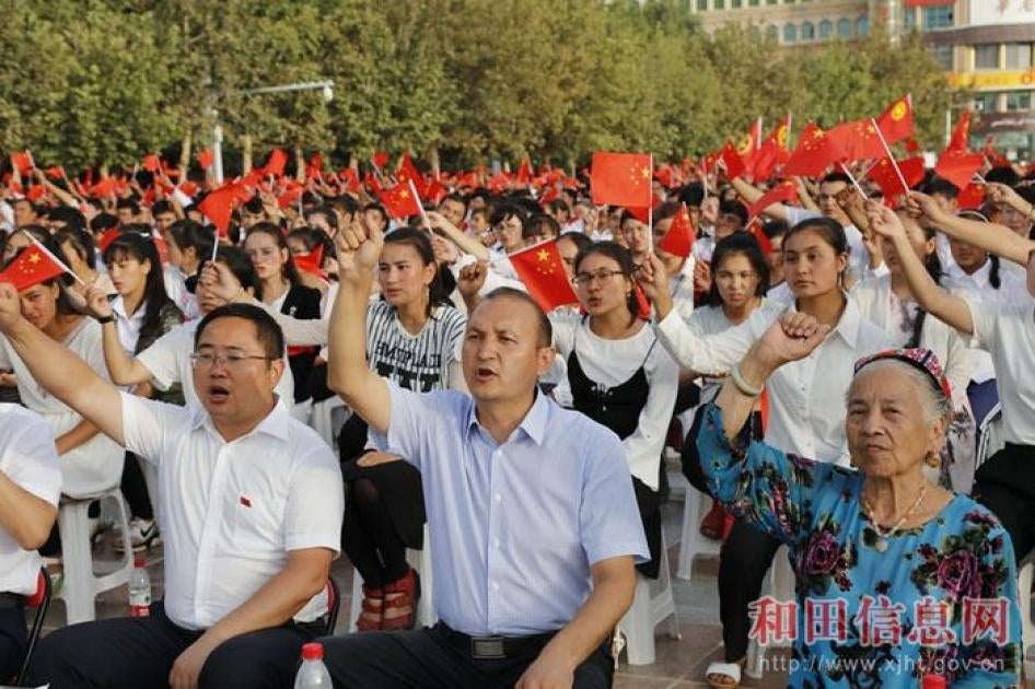 People denounce the “three evil forces” in a mass political meeting in Hotan, Xinjiang. 