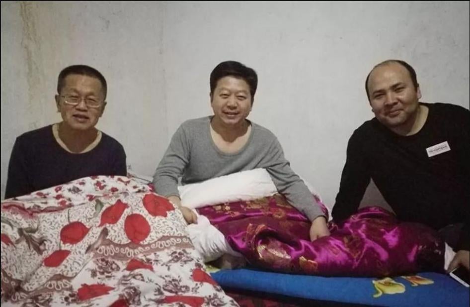 A state press photo showing Chinese officials sharing sleeping quarters with Turkic Muslim families during compulsory homestay “Becoming Family” program in Xinjiang. 