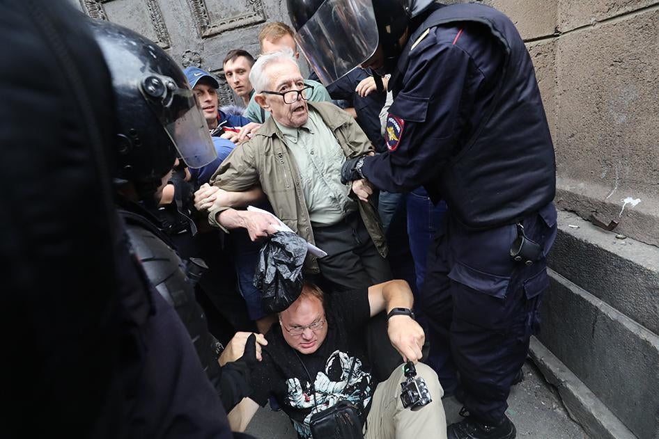 Police in St. Petersburg detain Yuri Sternik, a pensioner, in St. Petersburg, Russia.