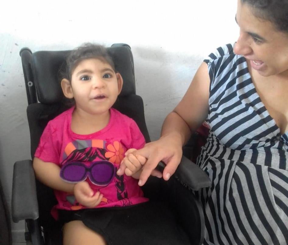 Maria Gabriela Silva Alves (“Gabi”), age 2, with her mother, Maria Carolina Silva Flor (“Carol”), at their home in Esperança, Paraíba state, Brazil in 2018. Gabi was one of thousands of children born with disabilities caused by exposure to the Zika virus 