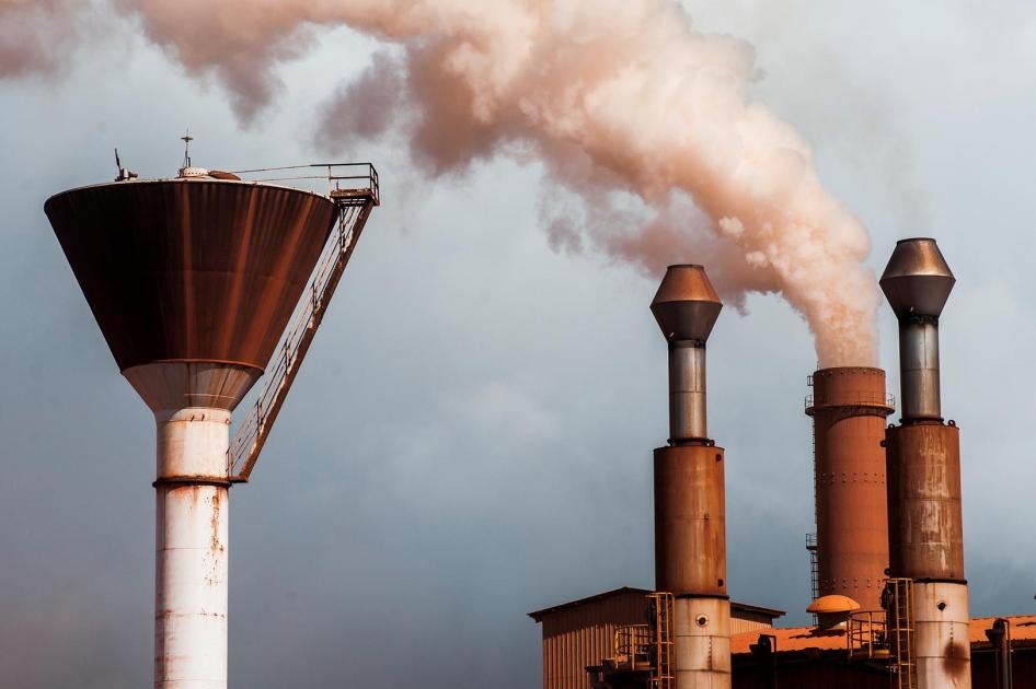A chimney emits smoke at a bauxite treatment plant operated by Compagnie des Bauxites de Guinee (CBG) in Kamsar, Guinea, on September 7, 2015. Local leaders have long expressed concerns about the impacts of the emissions on local air quality.