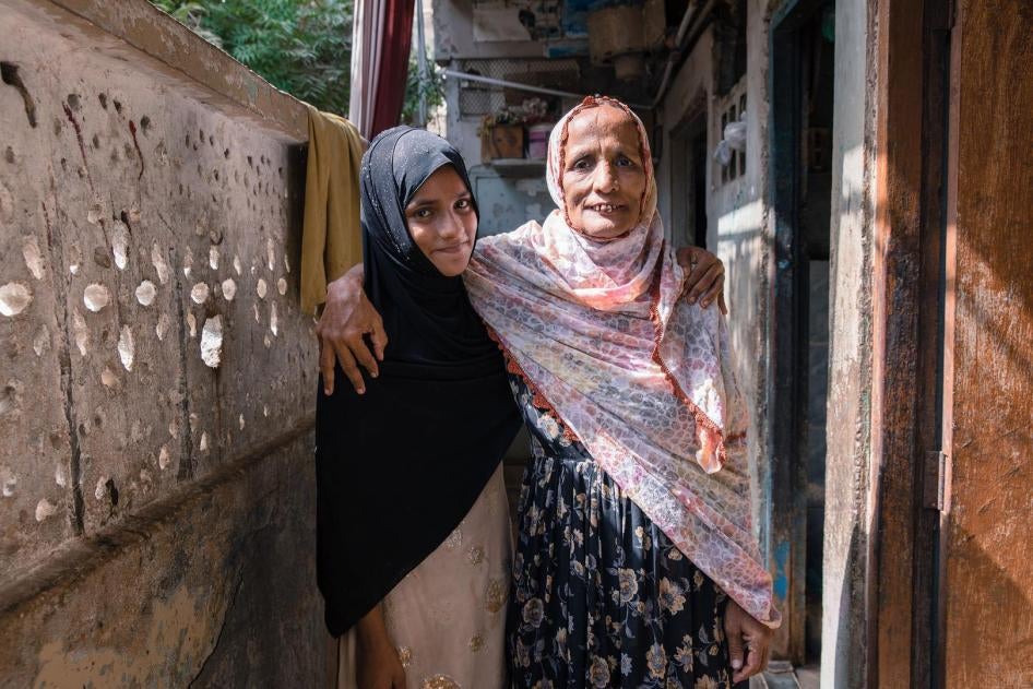 Saba, age 11, who does not attend school, with her mother. 
