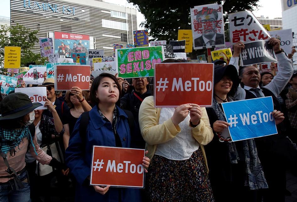 Protesters hold placards during a rally against harassment at Shinjuku shopping and amusement district in Tokyo, Japan, April 28, 2018