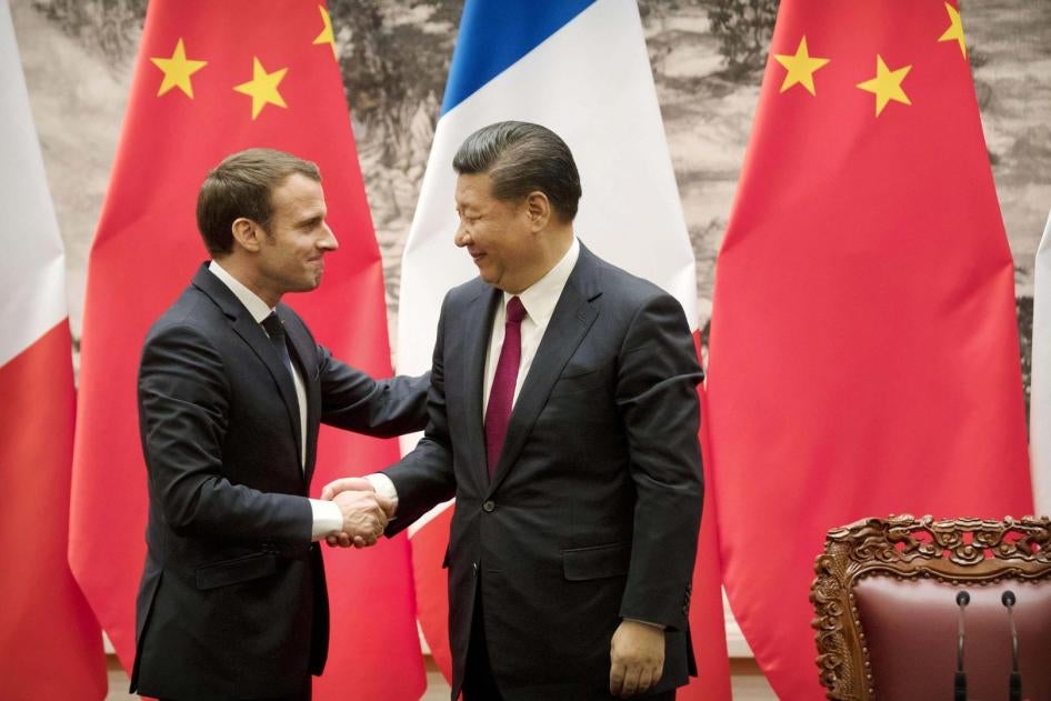 French President Emmanuel Macron and Chinese President Xi Jinping shaking hands after releasing joint press remarks at the Great Hall of the People in Beijing on January 9, 2018. © 2018 Kyodo via AP Images
