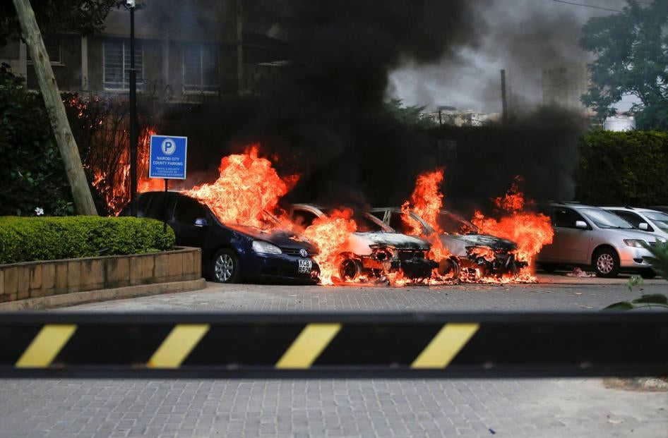 Burning cars are seen at the scene where explosions and gunshots were heard at the Dusit hotel compound, in Nairobi, Kenya January 15, 2019. 