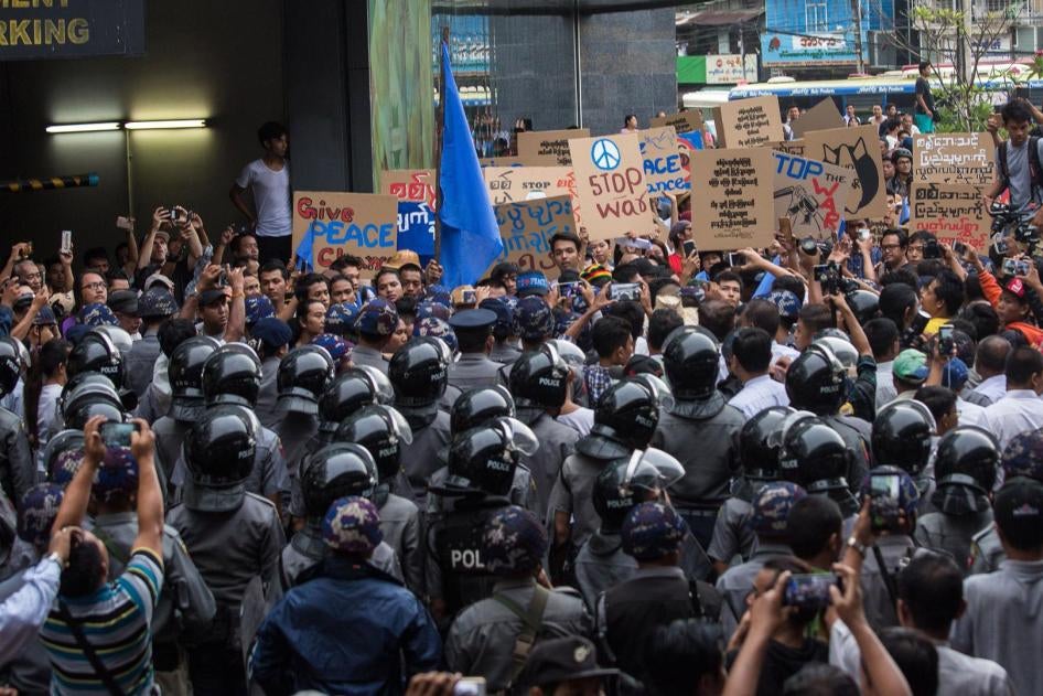 Myanmar police stop a group of demonstrators during an anti-war protest in Yangon, May 12, 2018. 