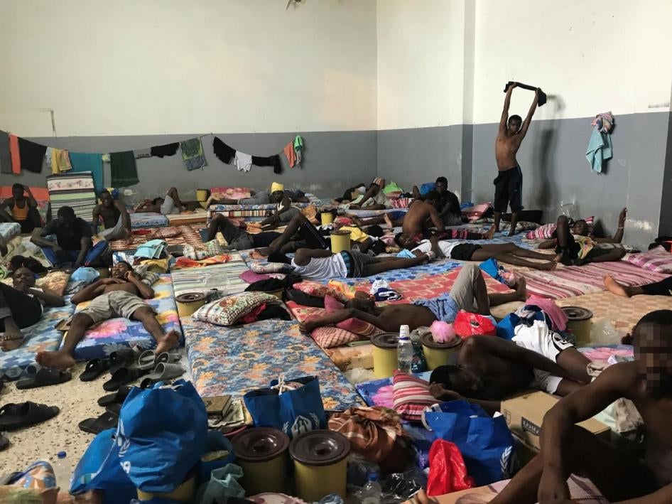 Men in crowded living space at Tajoura detention center, Tripoli, July 8, 2018. 