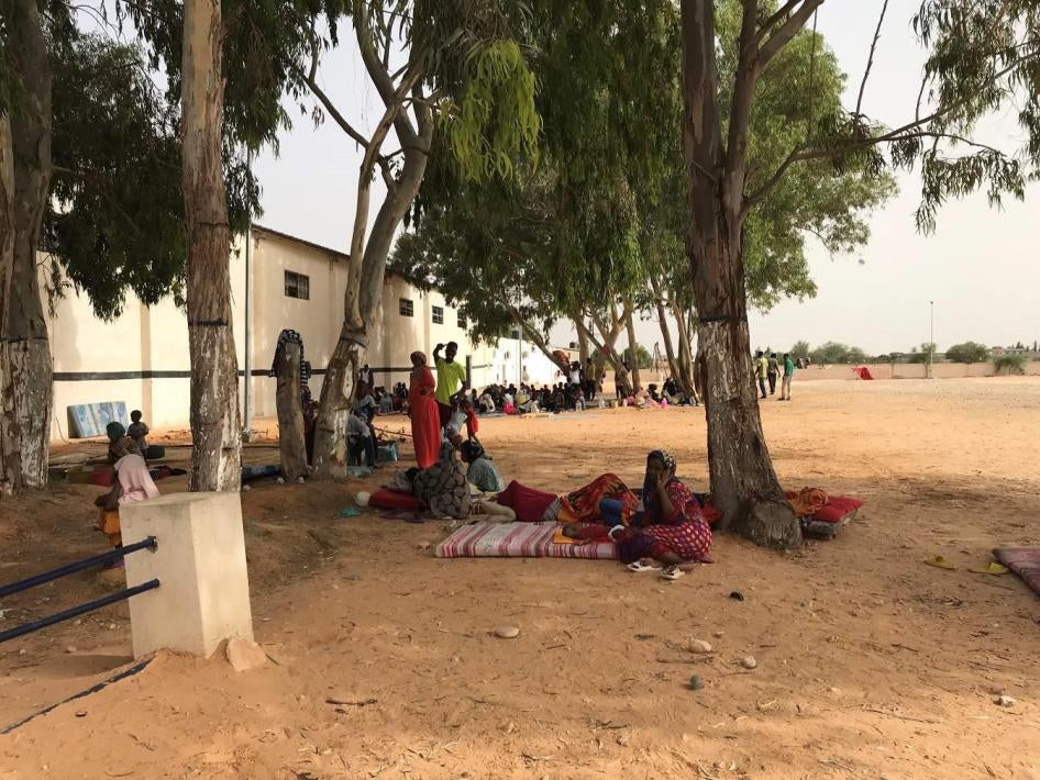 Women sit outside at Ain Zara detention center, Tripoli, July 5, 2018.