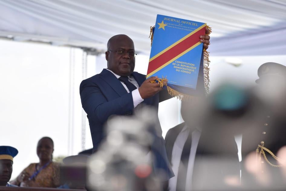 Felix Tshisekedi holds up the constitution after being sworn into office as president of the Democratic Republic of Congo, in Kinshasa, January 24, 2019.