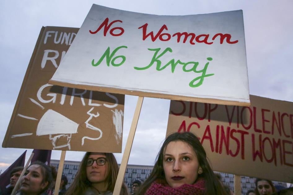 Women’s rights supporters at a demonstration for International Women’s Day in Krakow, Poland, on March 8, 2018. The center sign uses the slogan “No Woman, No Country.”