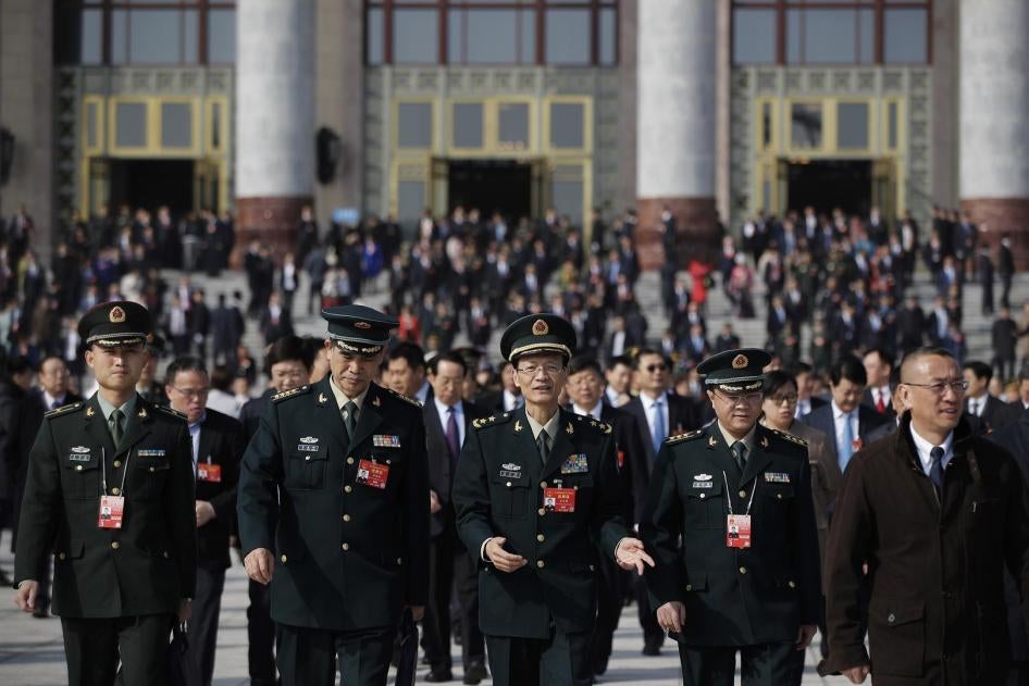 Delegates from China's People's Liberation Army chat as they leave the Great Hall of the People after attending a meeting ahead of Tuesday's opening session of China's National People's Congress in Beijing, Monday, March 4, 2019. 