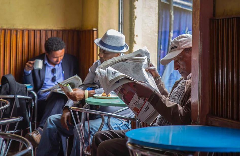 Ethiopian men read newspapers at a cafe during a declared state of emergency in Addis Ababa, Ethiopia. 