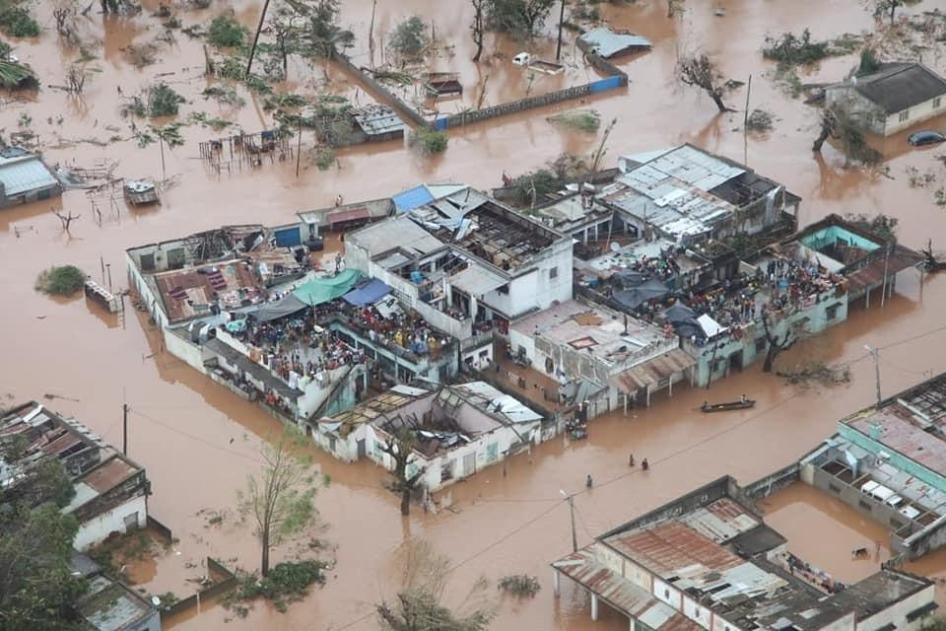 Residents of Buzi District, in Sofala province, Mozambique, wait on rooftops for rescue teams after Cyclone Idai, March 19, 2019.