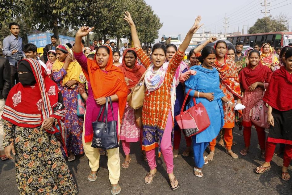 Bangladeshi garment workers shout slogans during a protest in Savar, on the outskirts of Dhaka, Bangladesh, Wednesday, Jan. 9, 2019. Thousands