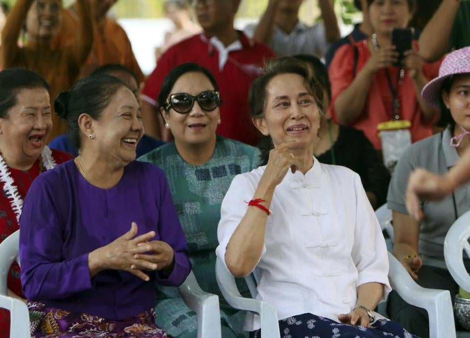 Myanmar's leader Aung San Suu Kyi, right, and first lady Cho Cho, left, smile as they take part in the first day of Myanmar traditional water festival, also known as Myanmar New Year, in Naypyitaw, Myanmar Saturday, April 13, 2019. 