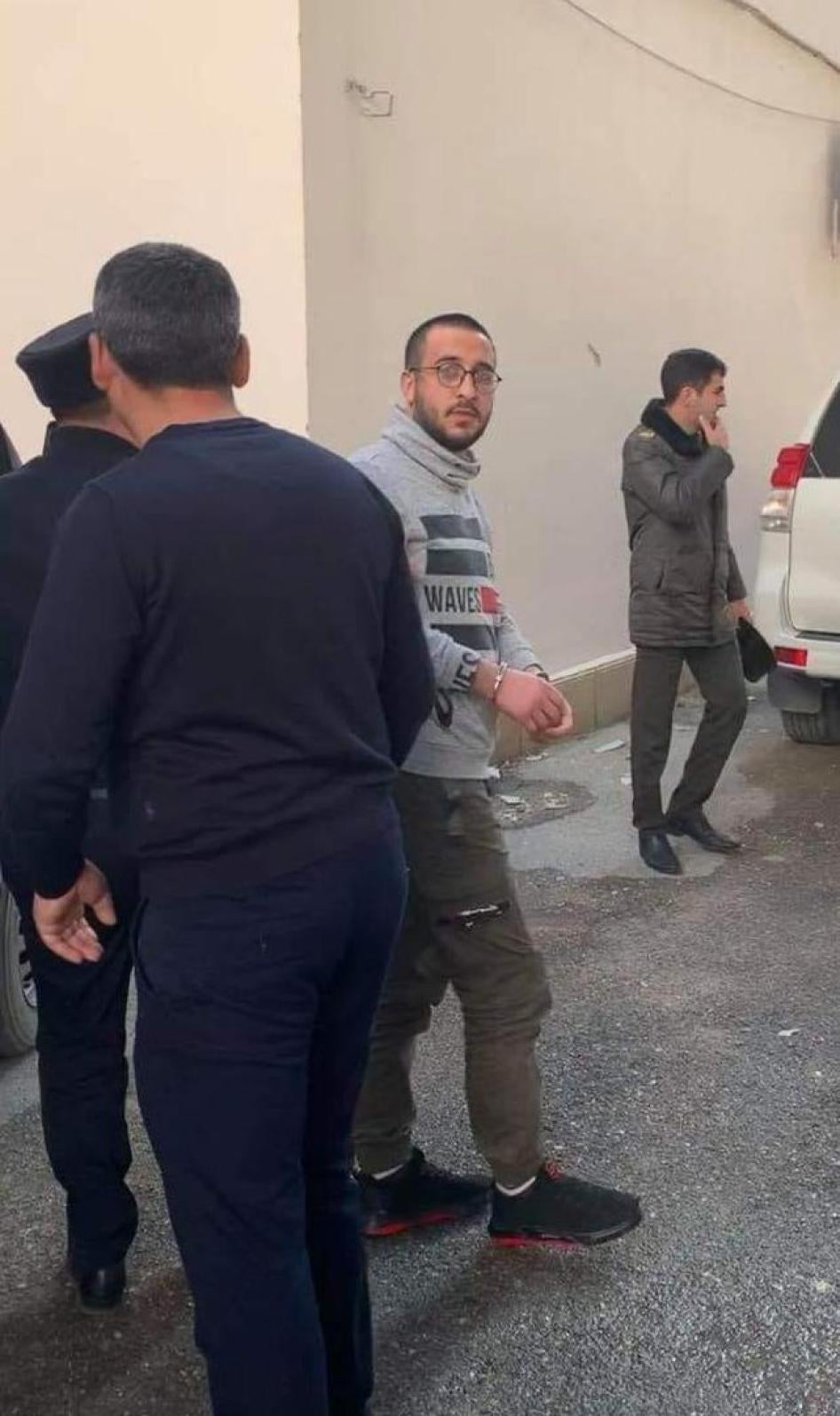 Policemen bringing youth activist Bayram Mammadov to the Appeal Court in Baku, Azerbaijan. April 2, 2019. 