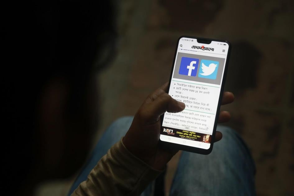 A Bangladeshi reads a news report that makes mention of Facebook along with other social networking service, on his mobile phone in Dhaka, Bangladesh, Thursday, Dec. 20, 2018. 