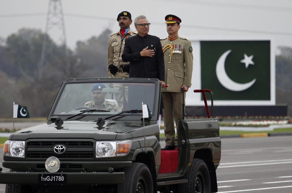 Pakistani President Arif Alvi, center on a military vehicle, reviews a military parade to mark Pakistan National Day, in Islamabad, Pakistan, Saturday, March 23, 2019.