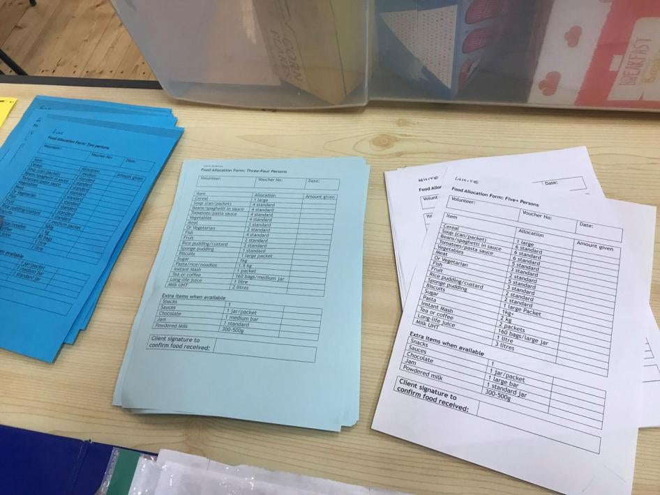 Food bank distribution forms at Ely Food Bank, Cambridgeshire, February 2018. Volunteers make up three day emergency supply parcels for food bank users based on the size of the family unit.   +Detail of what a three-day emergency supply for a “large famil