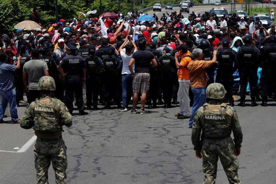 Mexican authorities stop a migrant caravan that had earlier crossed the Mexico - Guatemala border, near Metapa, Chiapas state, Mexico, Wednesday, June 5, 2019.